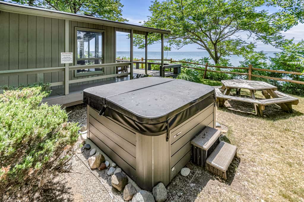 Quaint lakefront cottage w/ private hot tub, firepit, & beautiful sunset views
