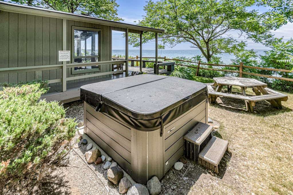 Quaint lakefront cottage w/ private hot tub, firepit, & beautiful sunset views