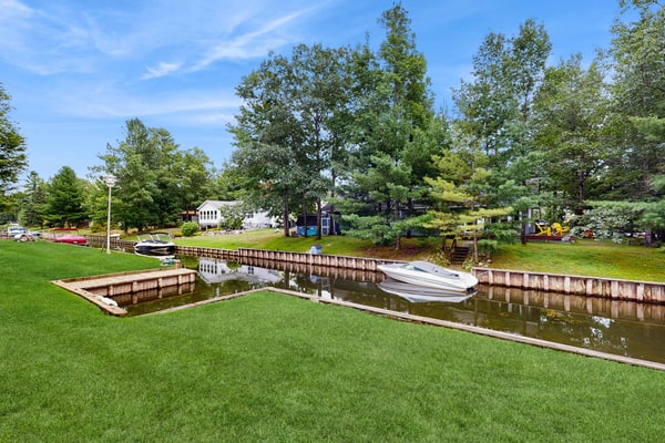 Cottage on the canal to Burt Lake with large patio and space for boat