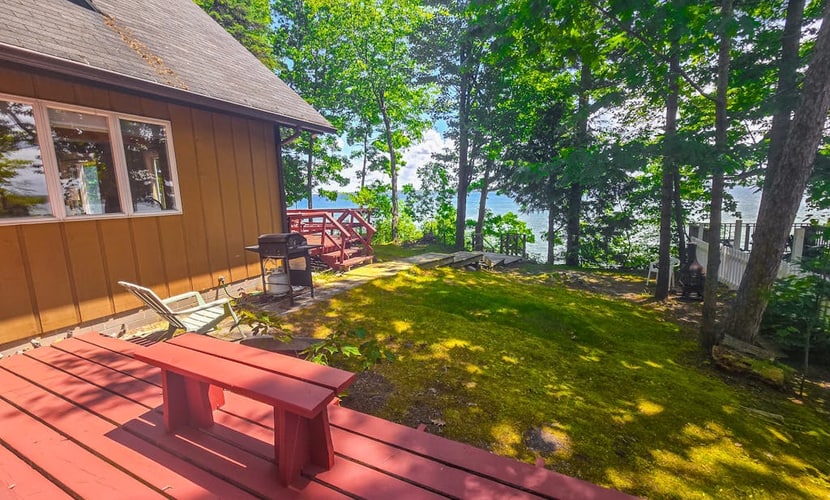 Incredible lakefront retreat with dock, fire pit, decks, yard, & amazing views