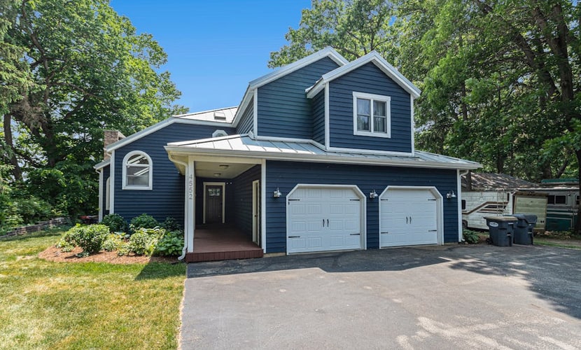 Serene lakefront retreat with an expansive deck, dock access, game room, & AC