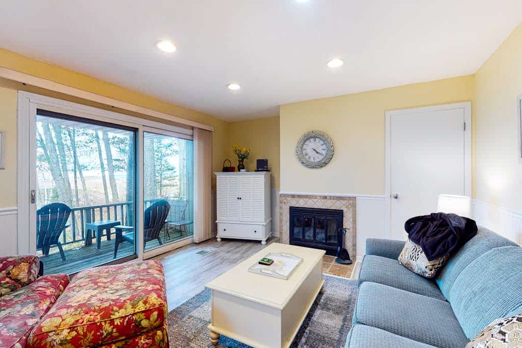 Riverfront condo with lake and river access, fireplace, firepit & gym