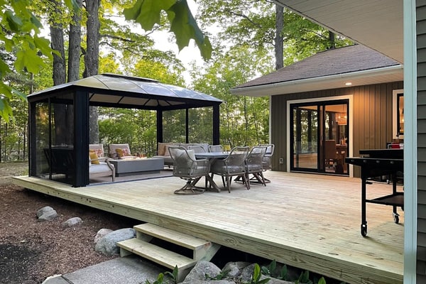 Modern Home in the woods w/ a large patio, gas grill, & near the lake