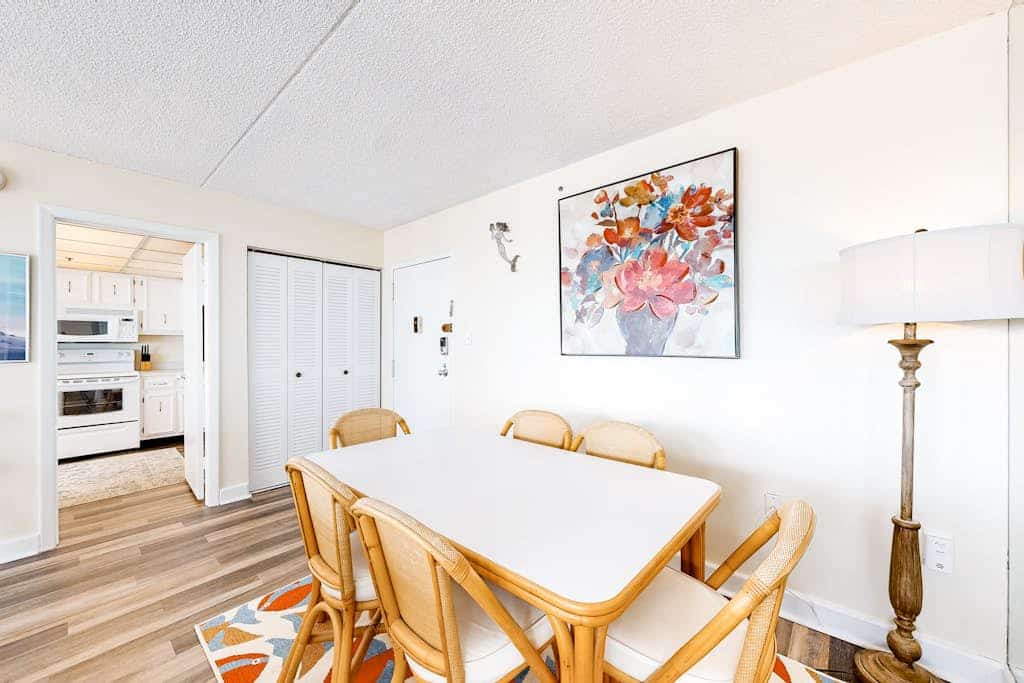 Bright coastal condo with pool access, side views of the ocean, balcony & W/D