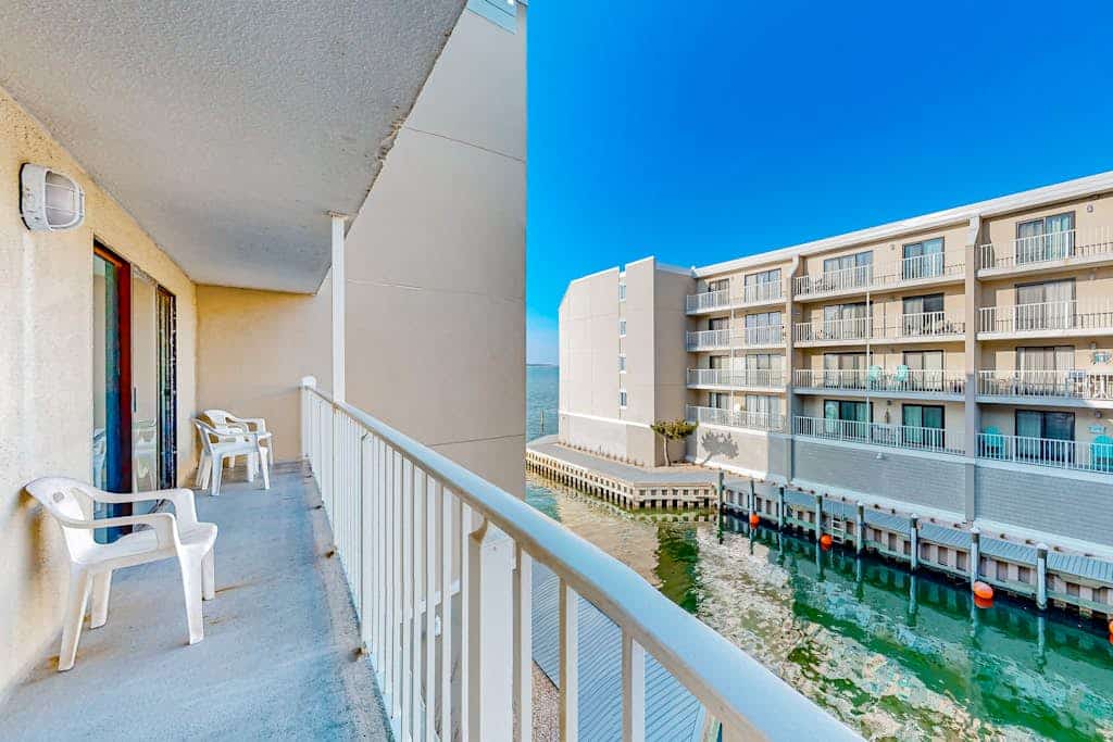 3rd-floor waterfront condo with outdoor pool, water views, balcony, W/D, AC