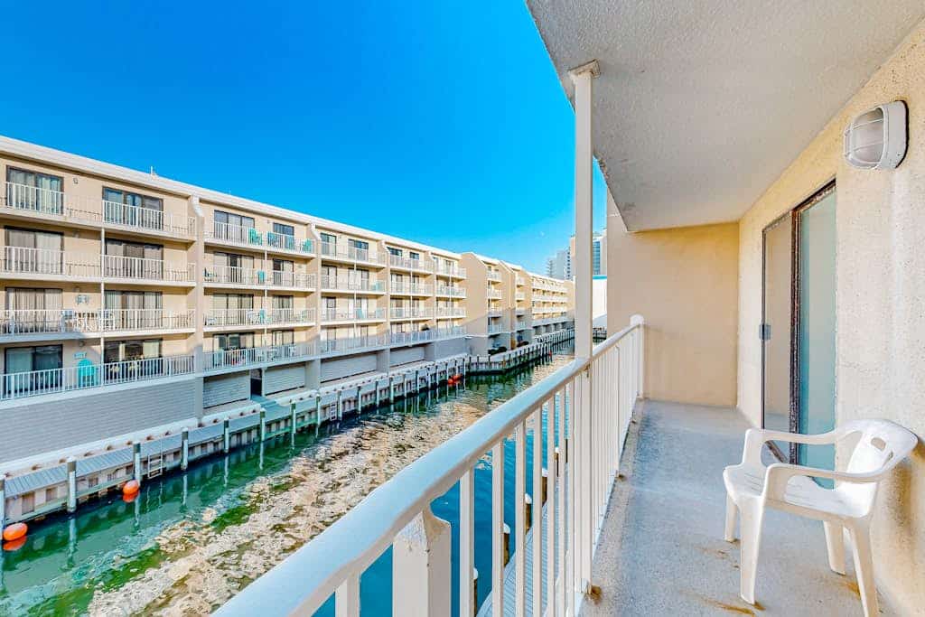 3rd-floor waterfront condo with outdoor pool, water views, balcony, W/D, AC
