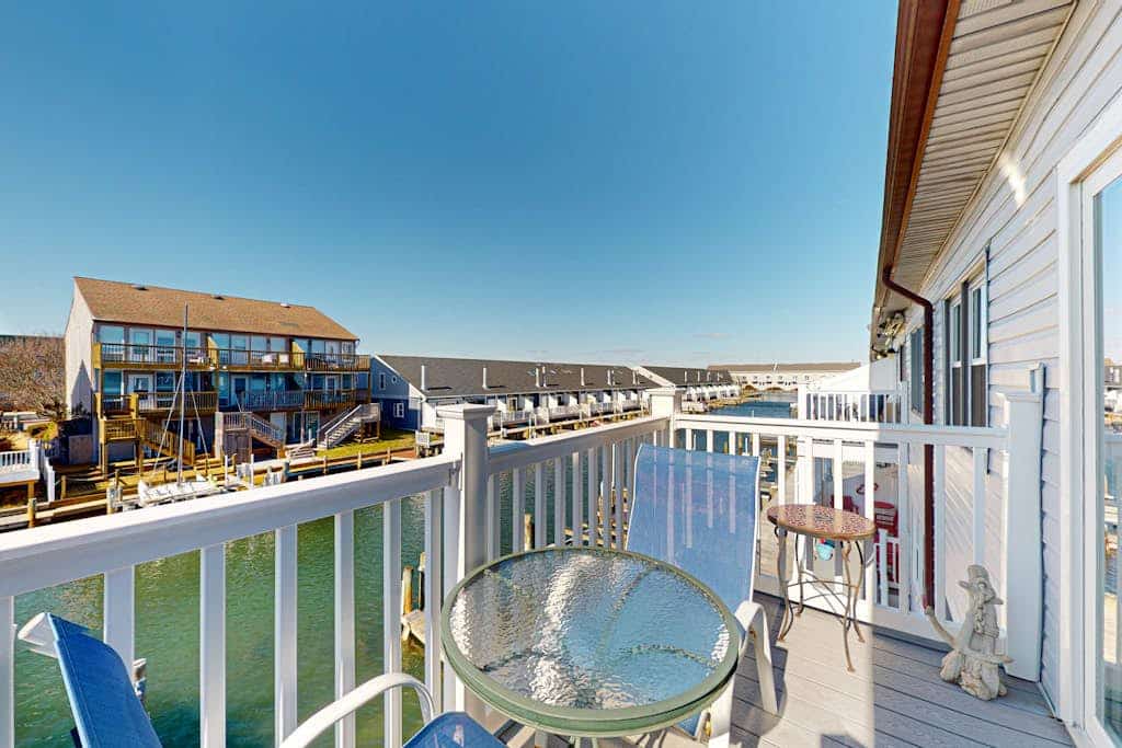Water view condo with peaceful balcony, open layout, smart TVs, games, & W/D