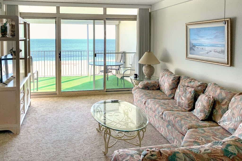 Open & charming home in oceanfront building with indoor pool, balconies, & AC