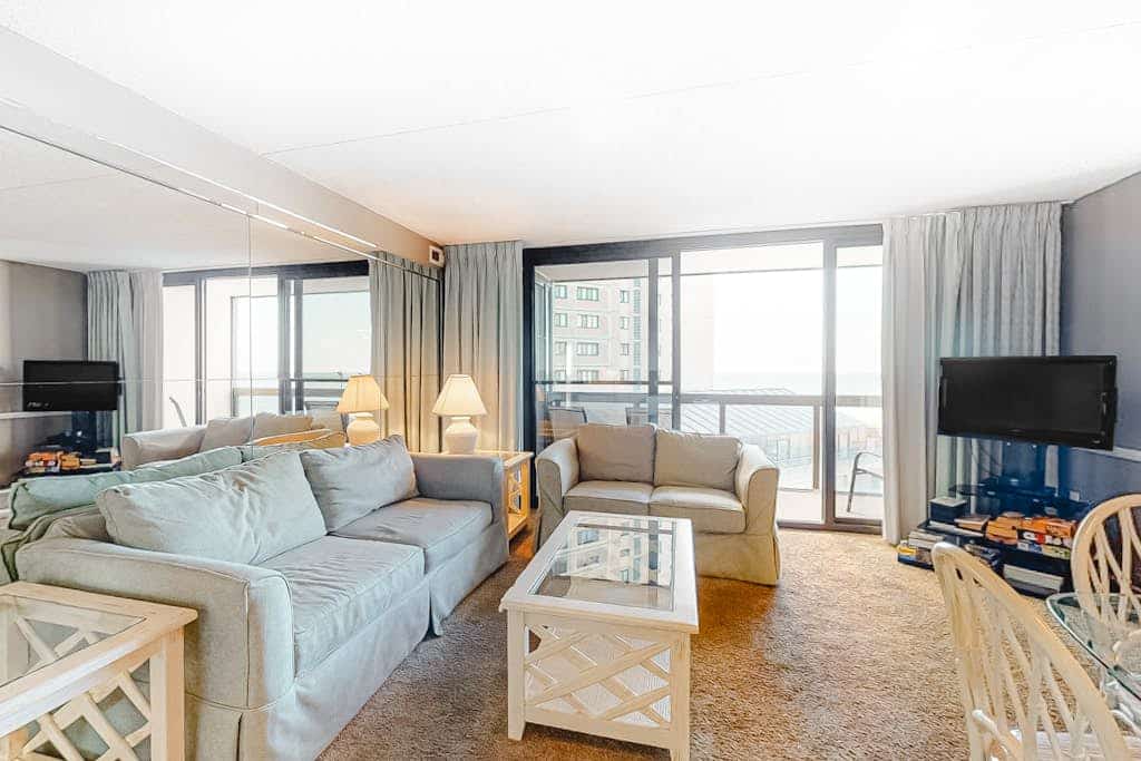 Light-filled beach condo with balcony, AC, angled views, pools, gym & sauna