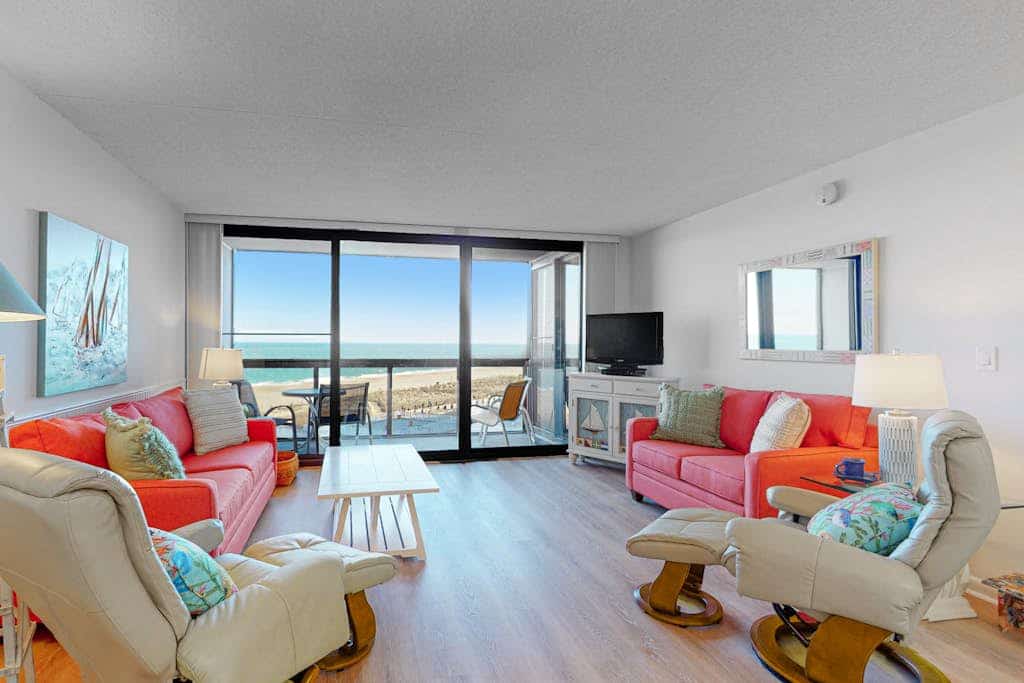 Modern beach retreat with balcony views, pools, gym & tennis