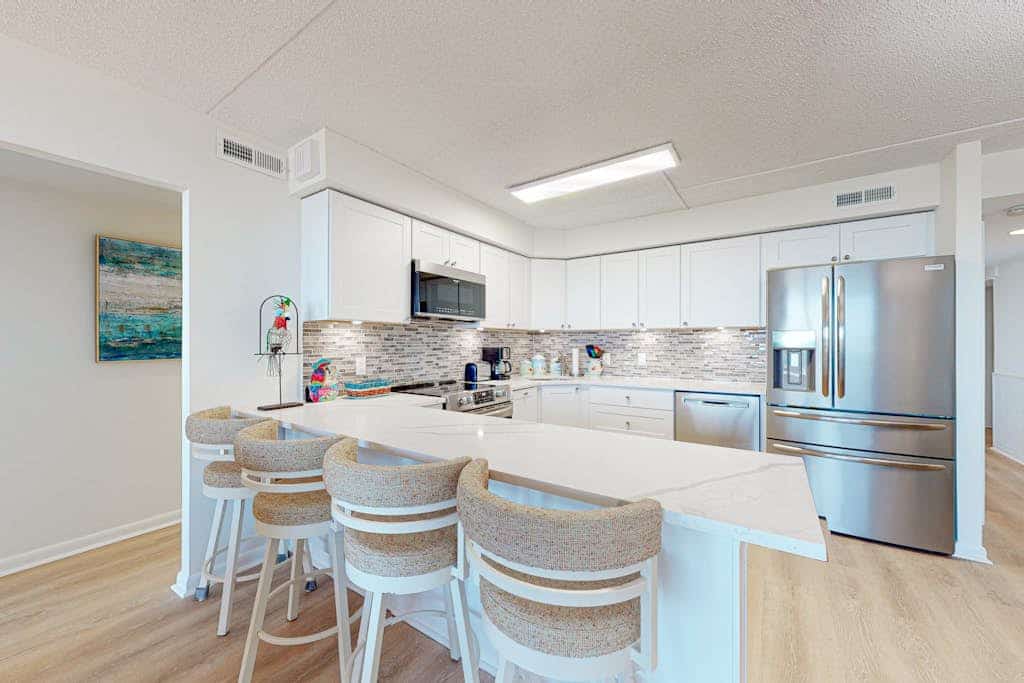 Modern beach retreat with balcony views, pools, gym & tennis