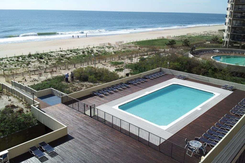 Oceanfront condo with pool, AC, balcony, & washer/dryer