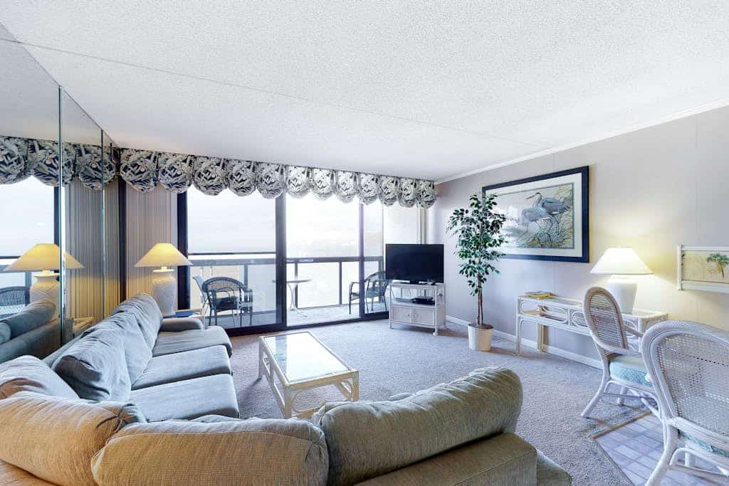 Sunny beachfront condo with balcony, central AC, pools & gym