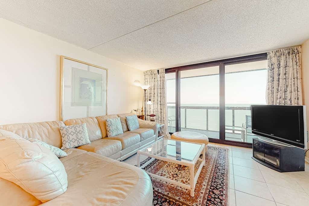 Elegant beachfront condo with balcony, W/D, AC, pools, sauna & gym