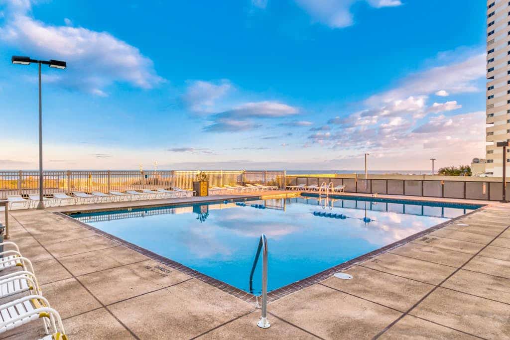 Captivating beachfront condo with balcony views, pools, gym & tennis court