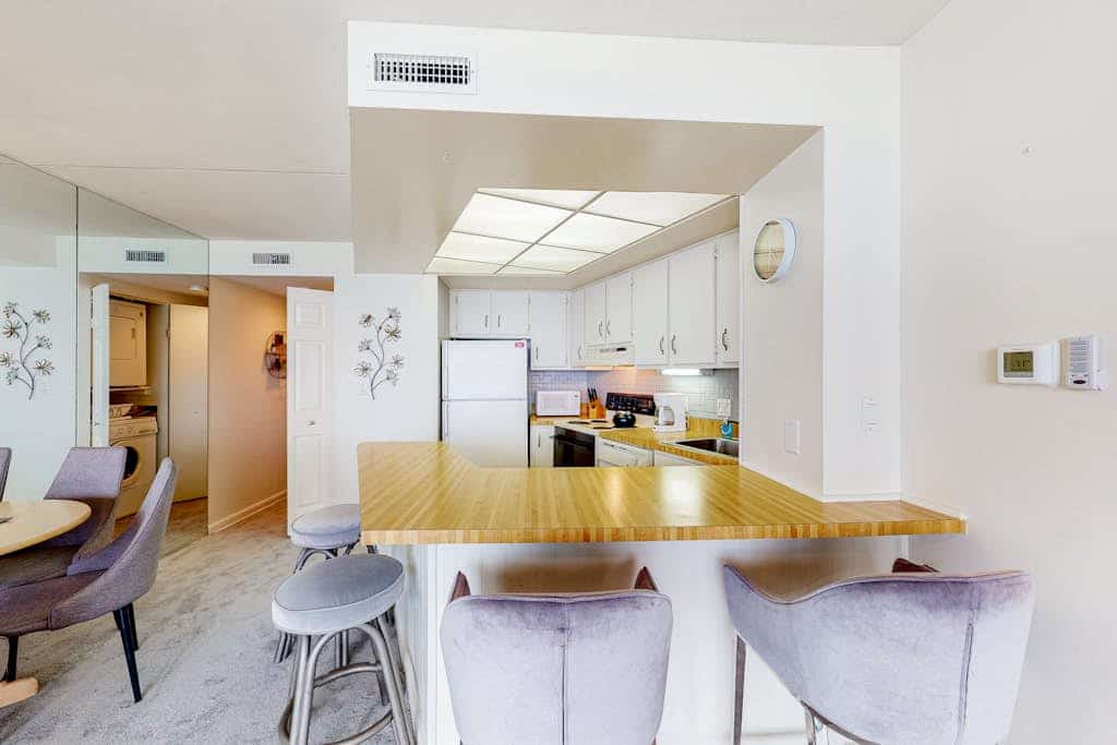 Waterfront condo with balcony, beach views, pools & gym