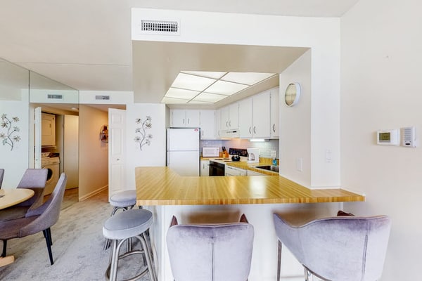 Waterfront condo with balcony, beach views, pools & gym