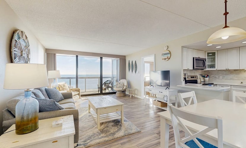 Convenient beachfront condo with balcony, pools, tennis, gym & central AC