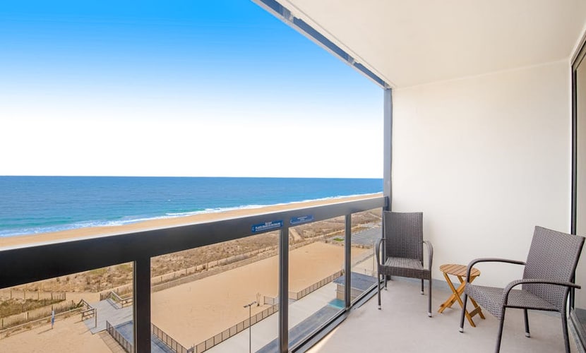 Wonderful beachfront condo with scenic balcony, AC, W/D, pools, gym, & tennis