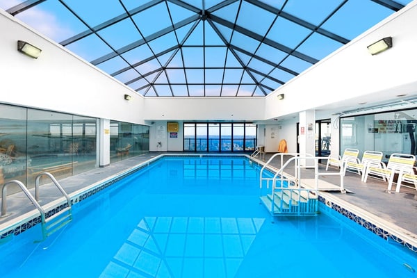 Wonderful beachfront condo with scenic balcony, AC, W/D, pools, gym, & tennis