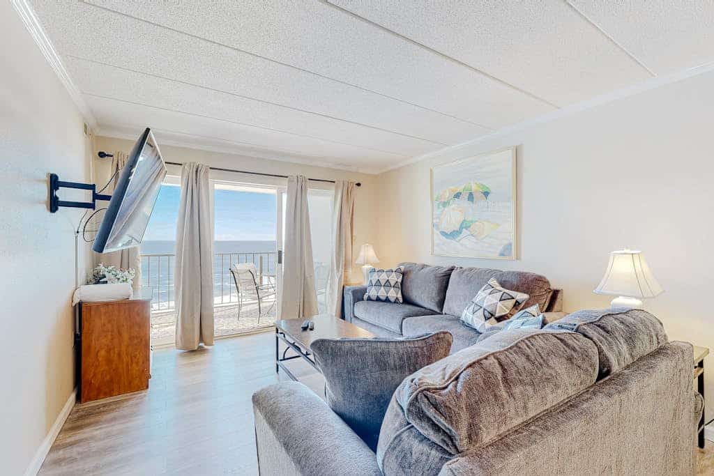 Sun-filled beach front condo w/ocean views balcony, W/D, hot tub, & full kitchen