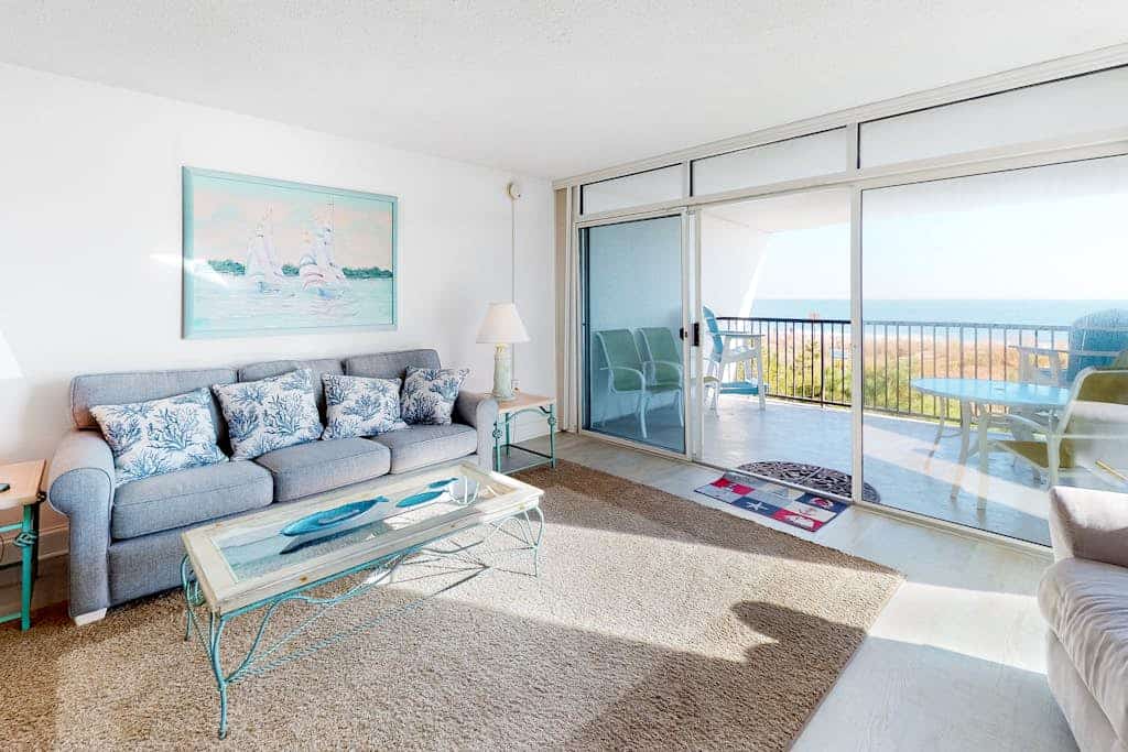Oceanfront condo with shaded balcony, WiFi, AC, washer/dryer, & pool