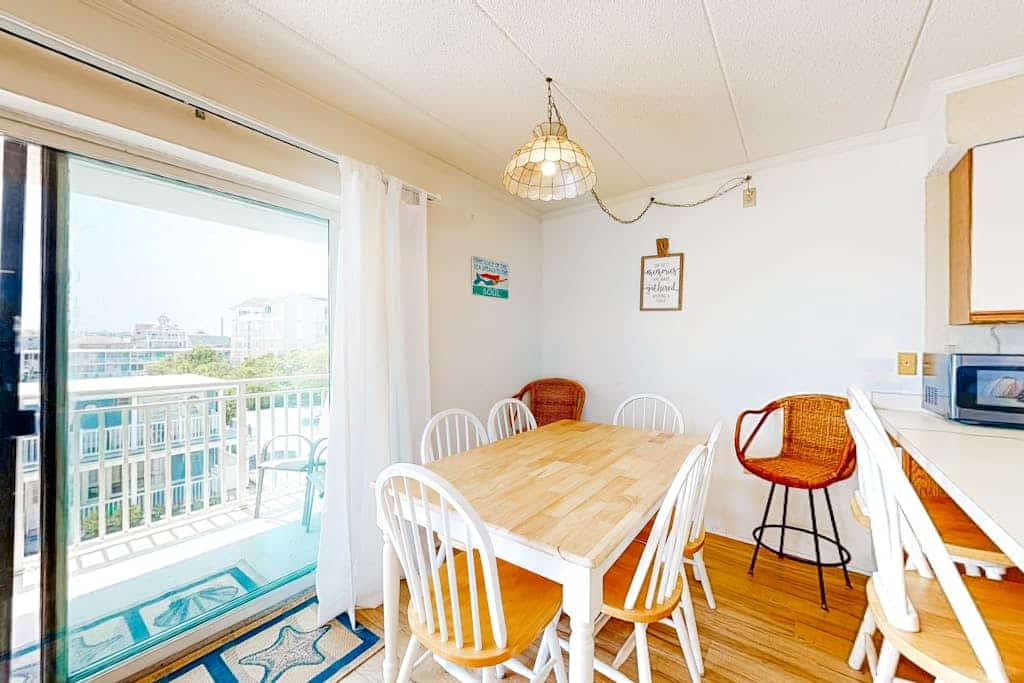 Attractive Mid-town beach condo with side beach views, private balcony, W/D & AC