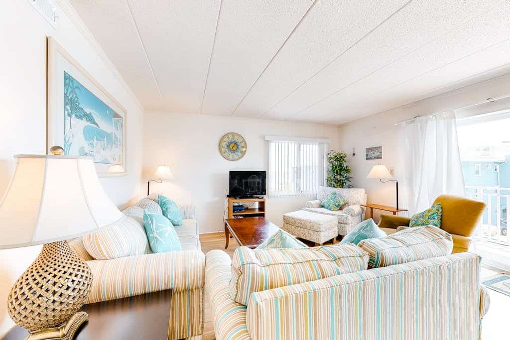 Attractive Mid-town beach condo with side beach views, private balcony, W/D & AC