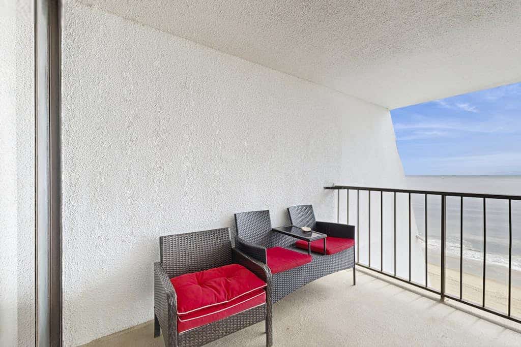 Oceanfront Condo with a Shaded Balcony, AC, WiFi, Laundry & Shared Pool