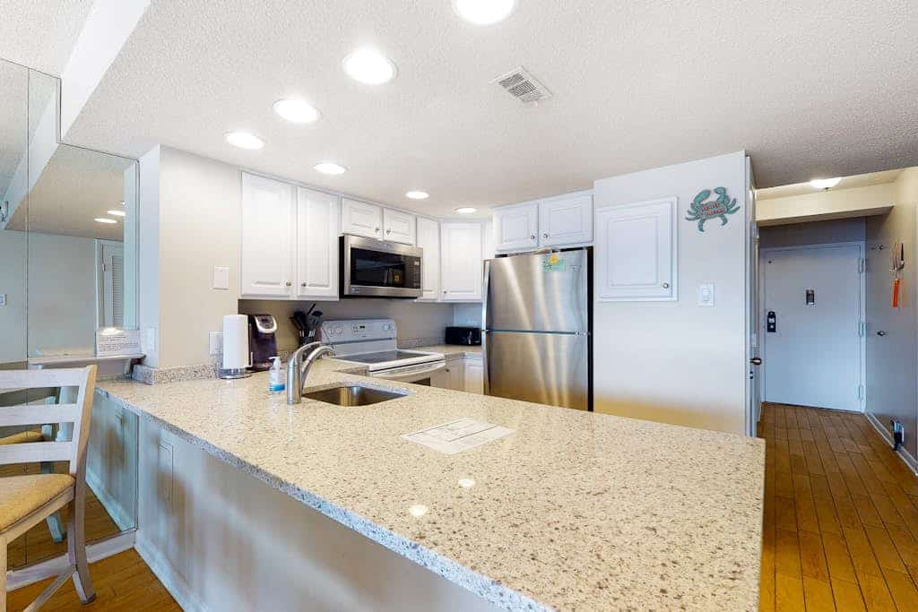 Beachfront corner condo with balcony, views, pools, game room, gym & sauna