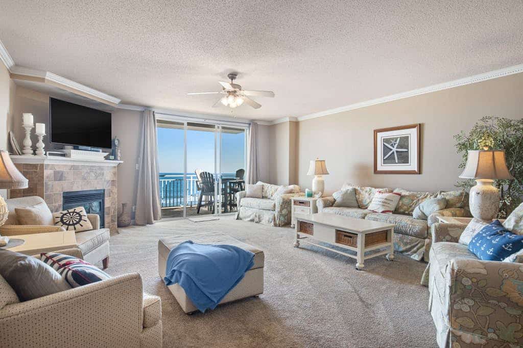 Sunny beachfront condo with pool access, large balcony & washer/dryer