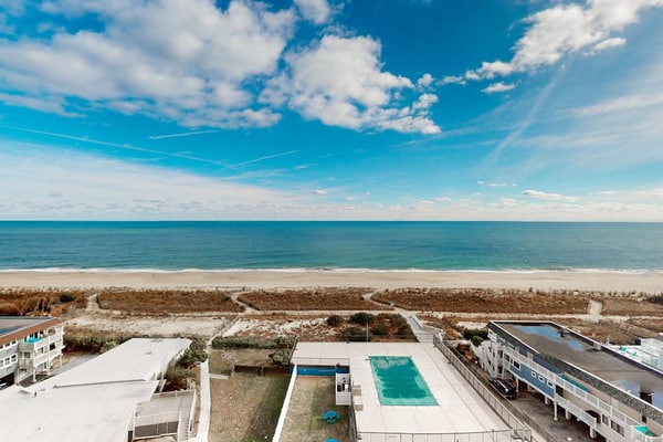 Beachfront condo with bay/ocean views, outdoor pool, & tennis courts