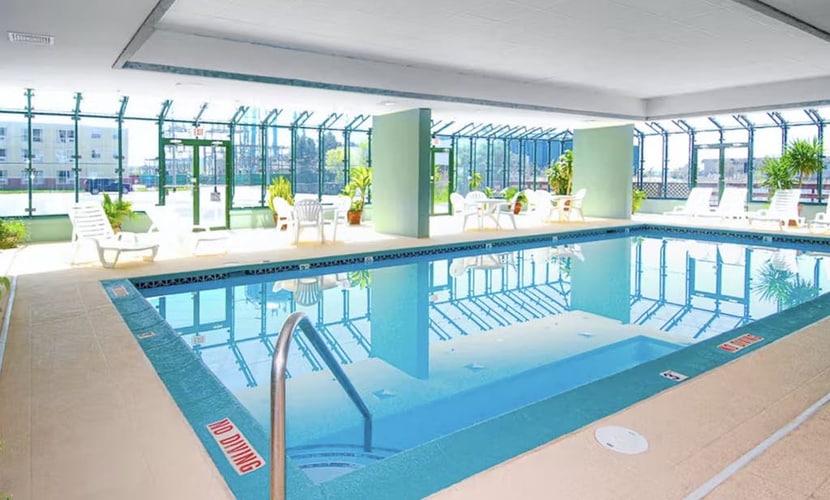 4th-floor studio with partial bay views, heated pool, gym, sauna, balcony, & AC