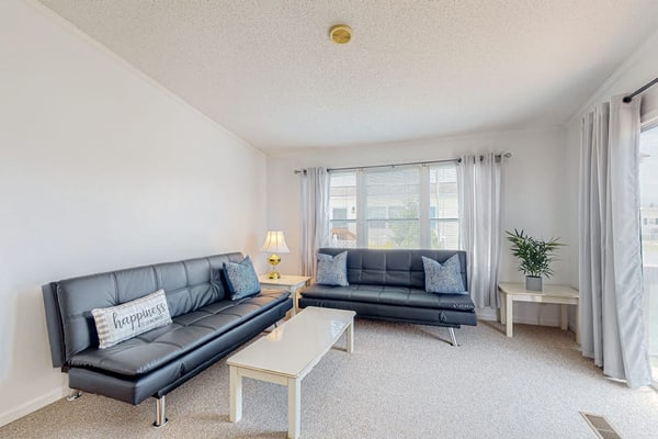 Sunny coastal home with private patio, on-site pool, central AC, & W/D