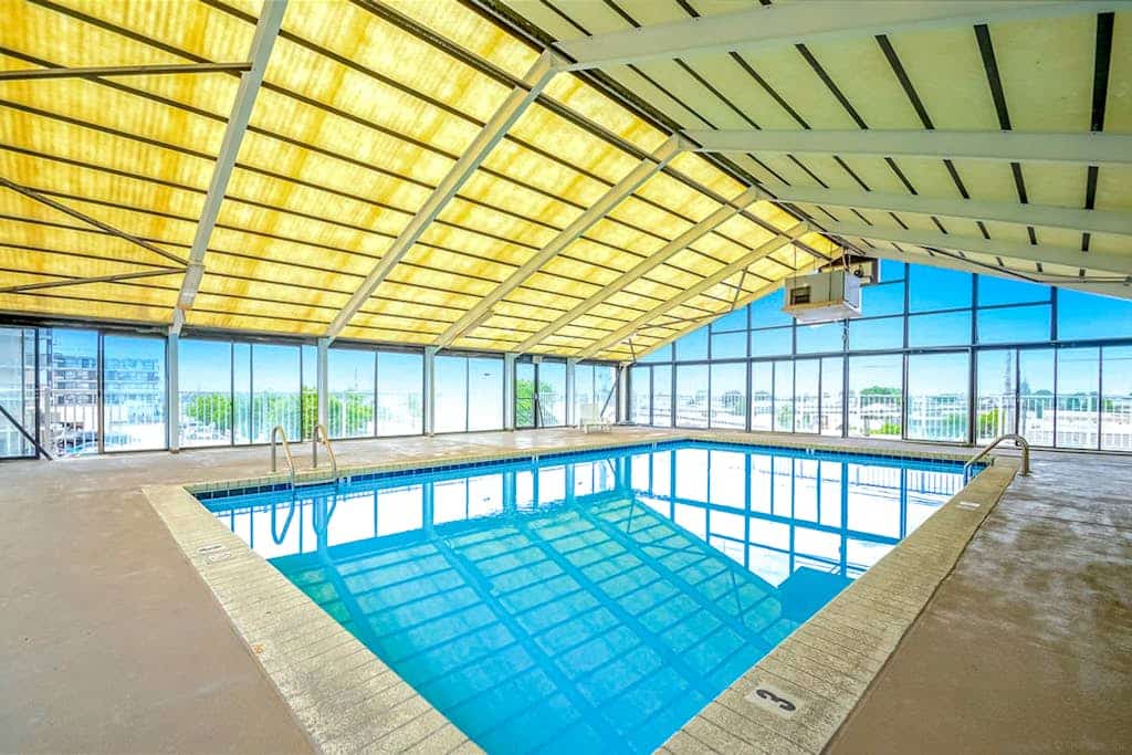 Updated, third-floor condo with balcony, W/D, central AC, & WiFi - near beach