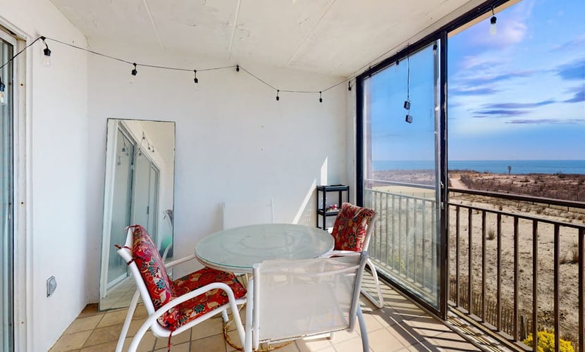 Waterfront condo with a scenic balcony, pool, beach access, AC, & W/D