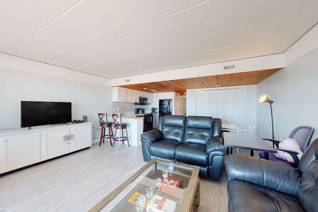 Waterfront condo with a scenic balcony, pool, beach access, AC, & W/D