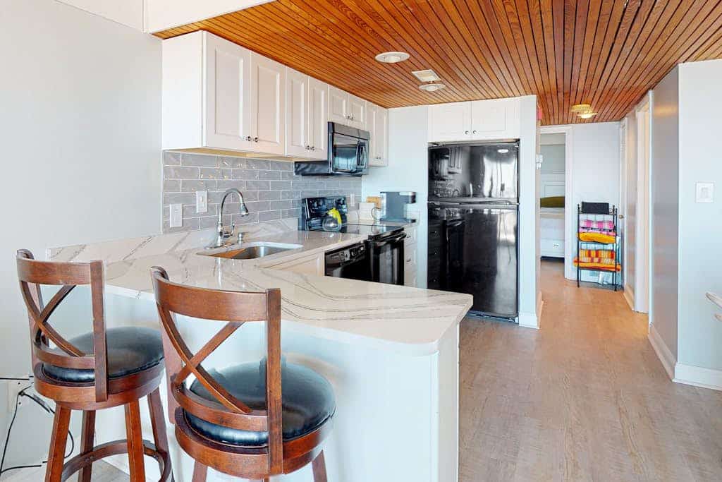 Waterfront condo with a scenic balcony, pool, beach access, AC, & W/D