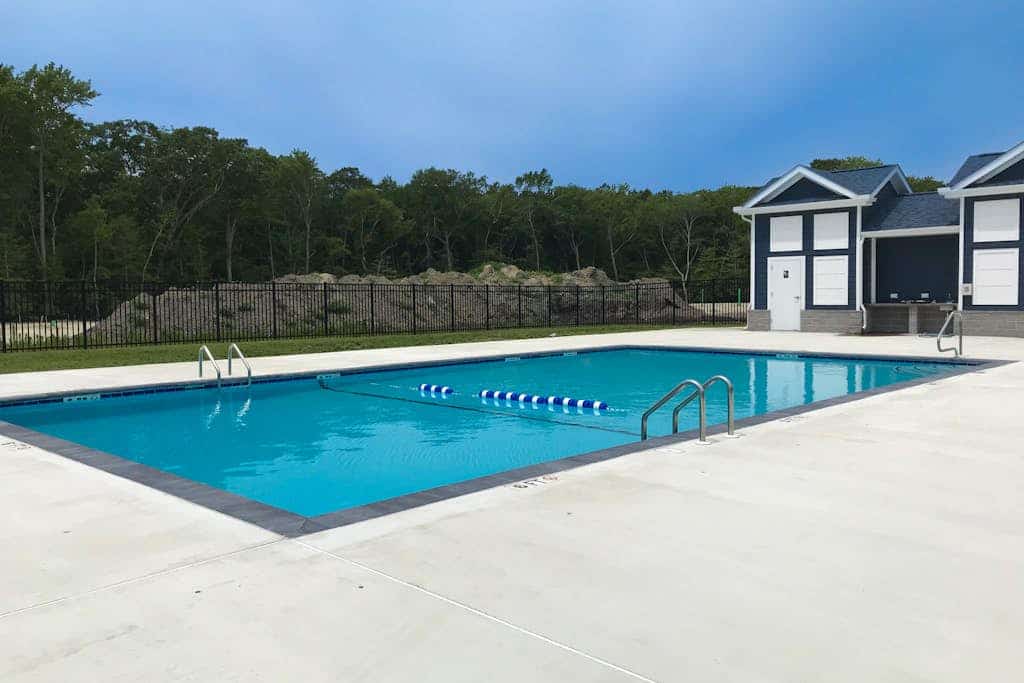 Newly built row-end townhome with water view, pool access, patio, & balcony