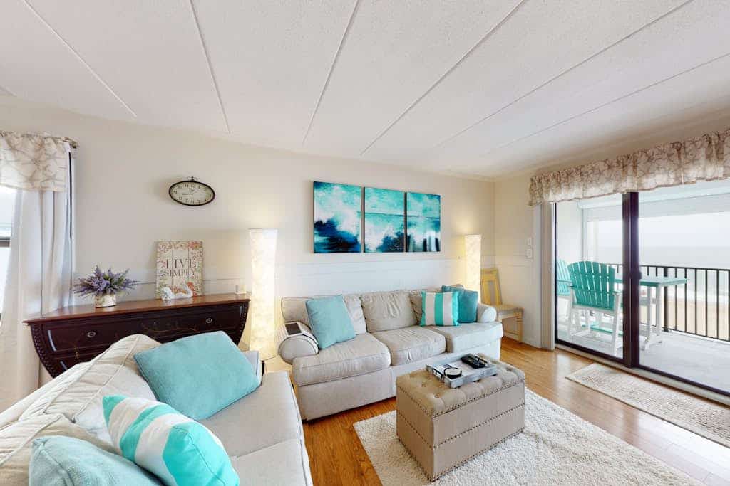 Waterfront condo with effortless beach access, private balcony, games, W/D, & AC
