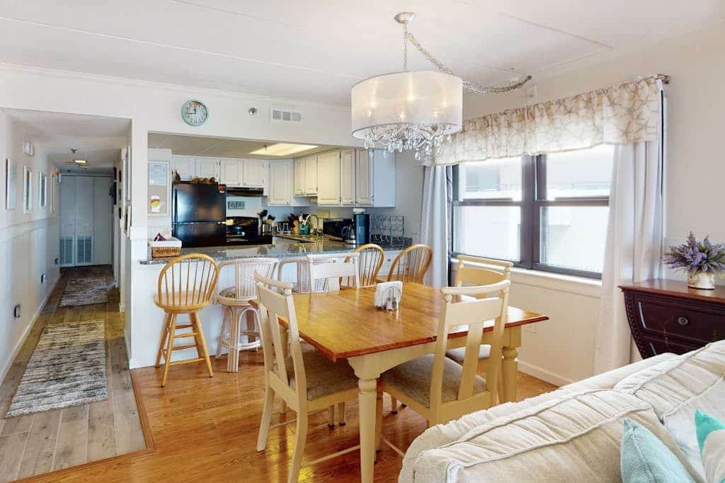 Waterfront condo with effortless beach access, private balcony, games, W/D, & AC