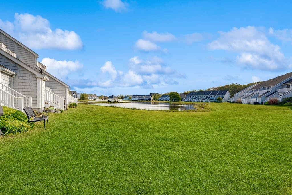 End-unit townhome with resort amenities, water view, balcony, fireplace, & AC