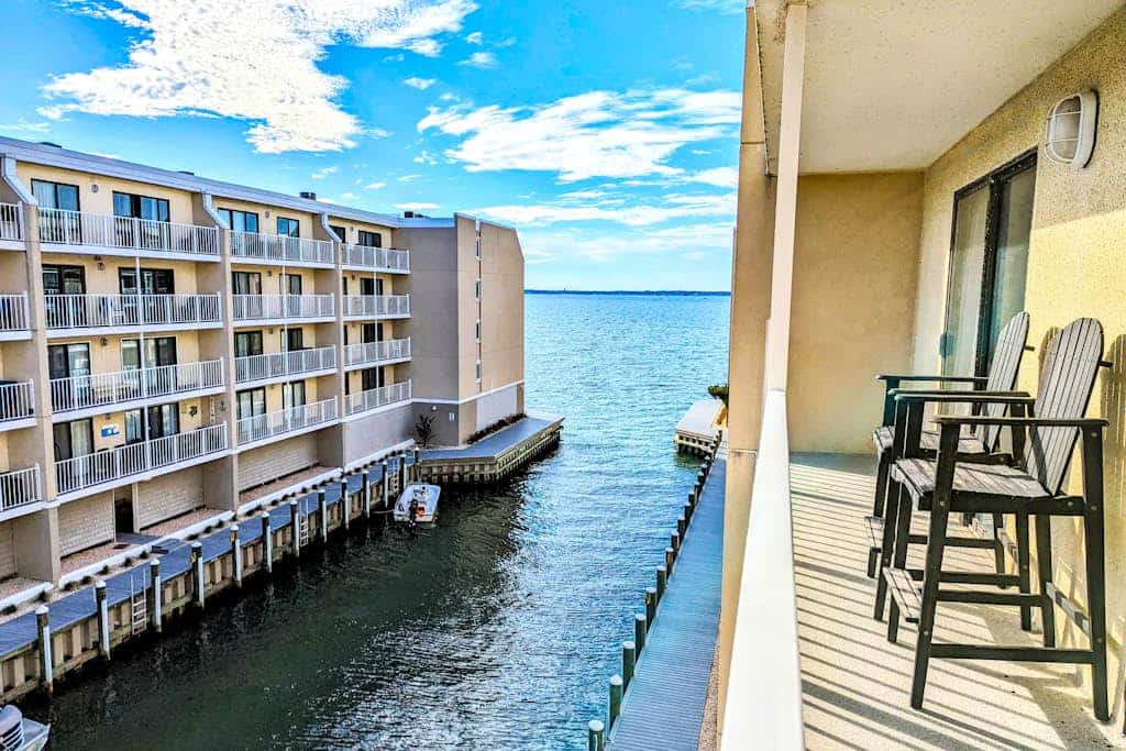 Canal view condo with pool & grill access - scenic balcony, open layout, and AC