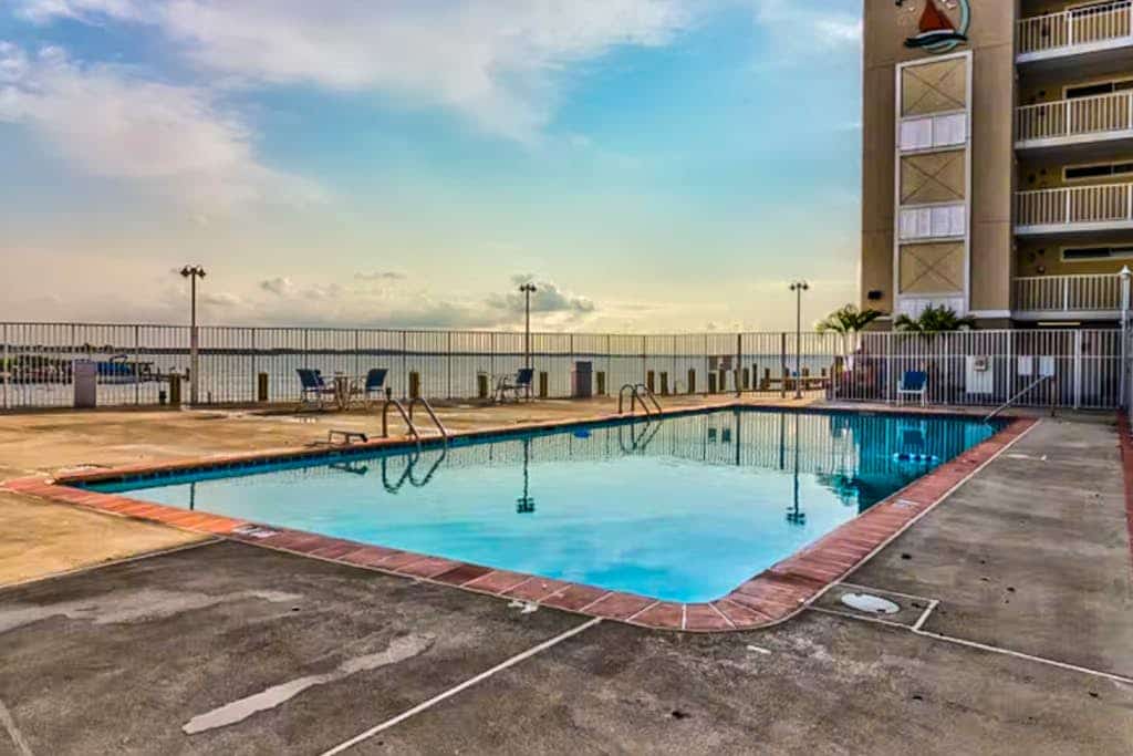 Canal view condo with pool & grill access - scenic balcony, open layout, and AC