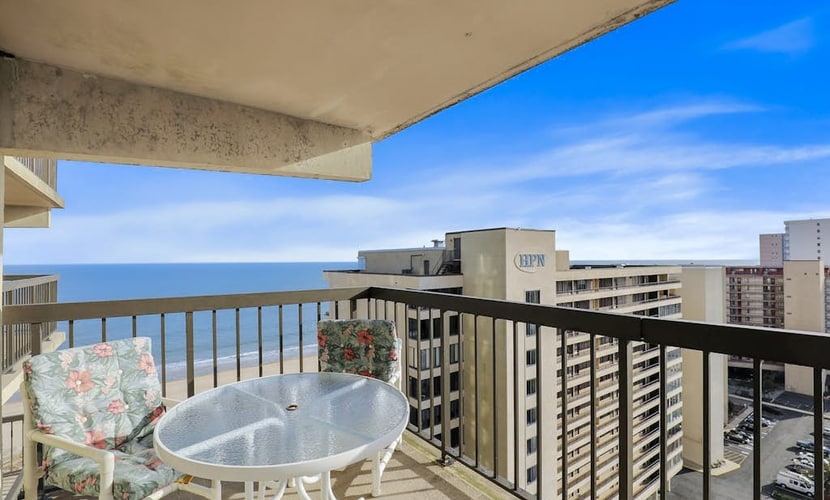 Bright beach condo with balcony, views, pool, game room, tennis court & AC