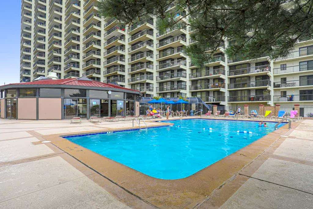 Bright beach condo with balcony, views, pool, game room, tennis court & AC