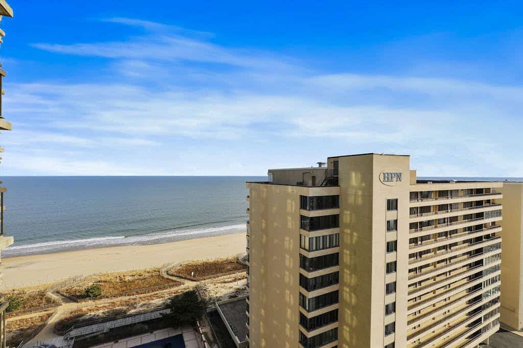 Bright beach condo with balcony, views, pool, game room, tennis court & AC