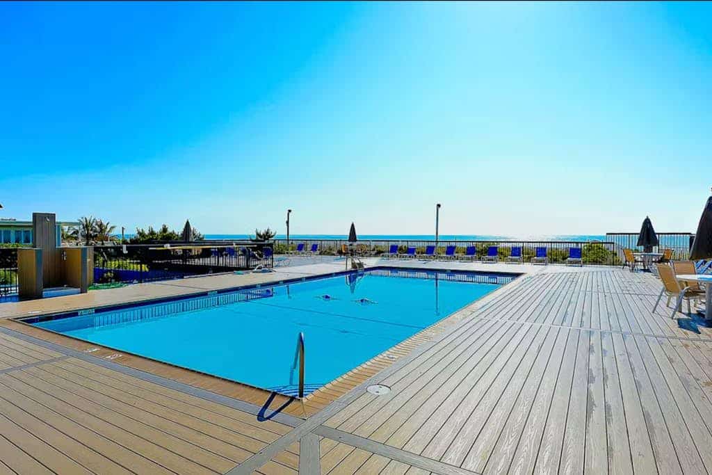 Beachfront condo with outdoor pool, water/sunset views, & shared tennis court