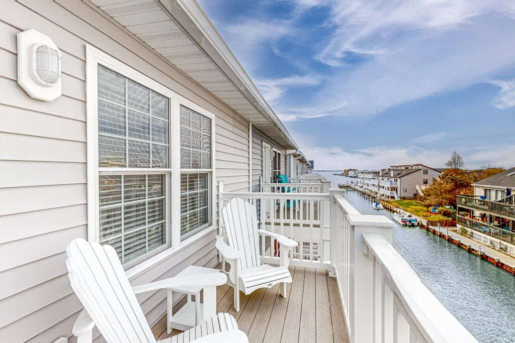 Upscale canal-front townhome with pool, beach access, dock, balconies, & desks