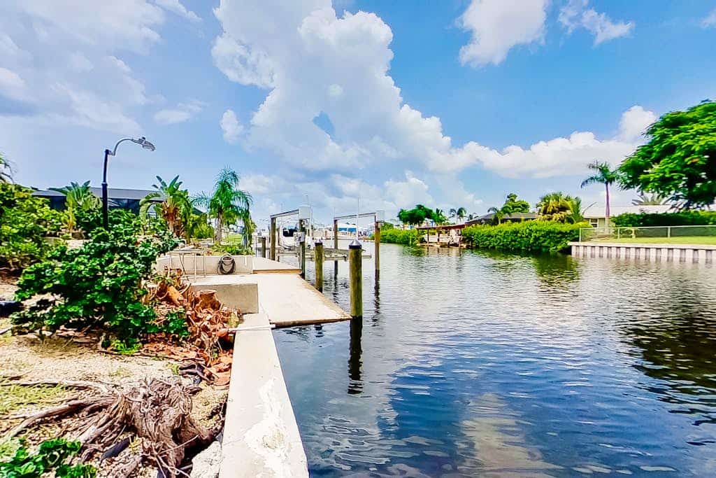 Private home on the canal with dock, screened pool, patio, AC, & W/D - dog-friendly